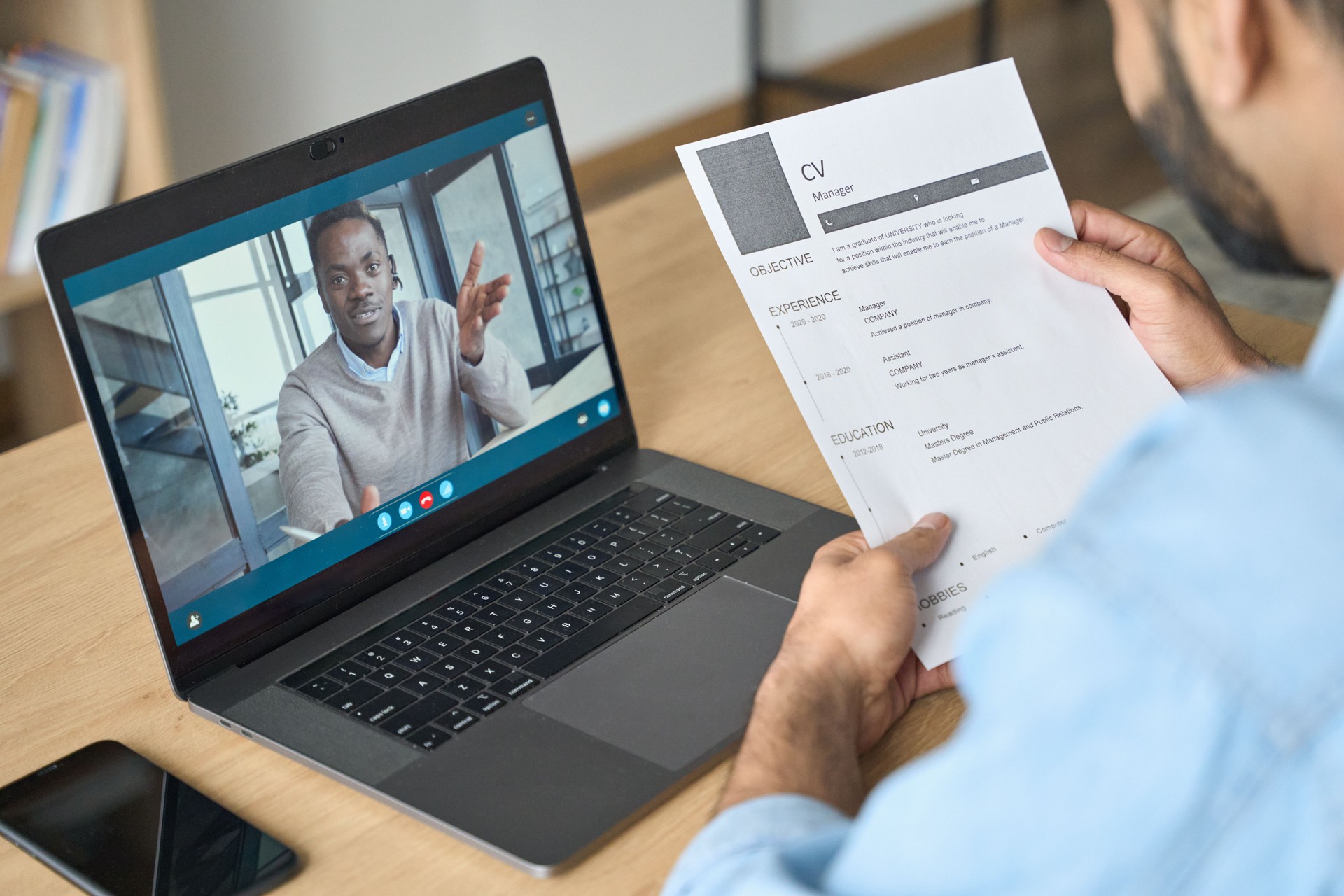 Young indian businessman having video call talking to potential employee.